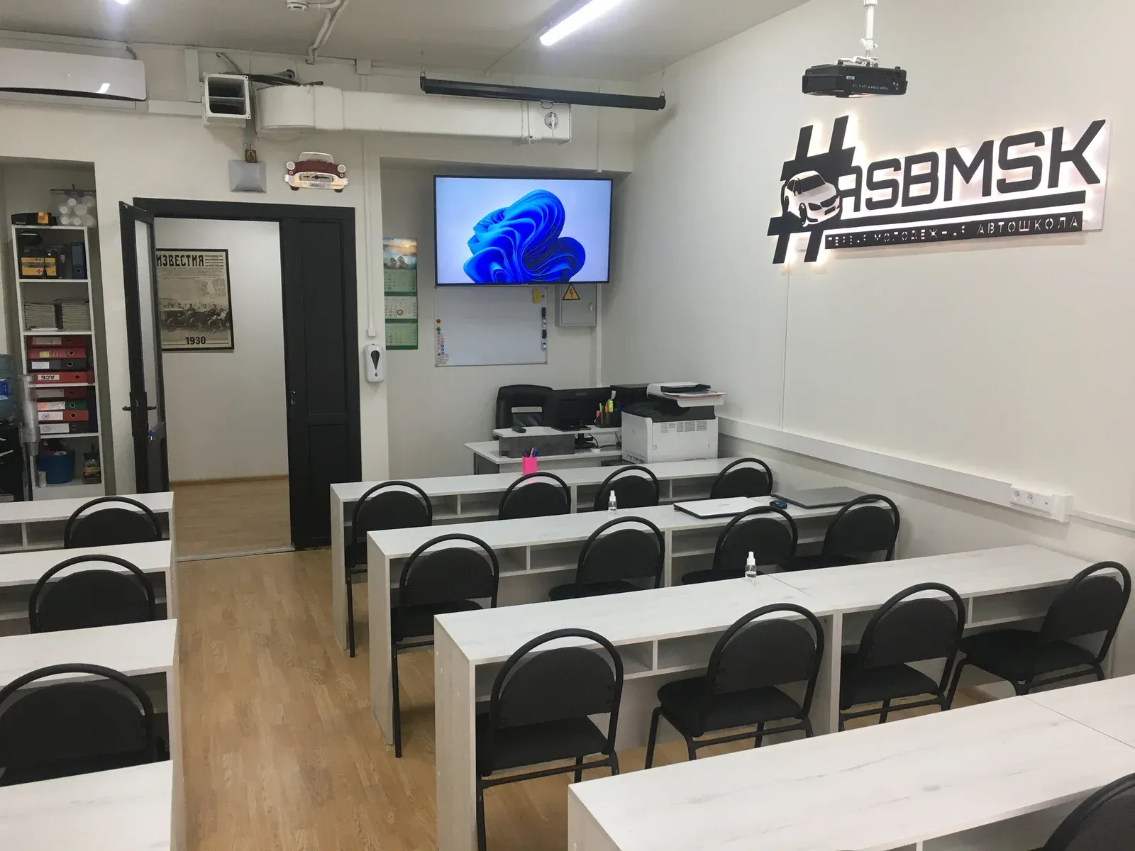 Учебный класс автошколы АСБ с экраном и фирменной вывеской